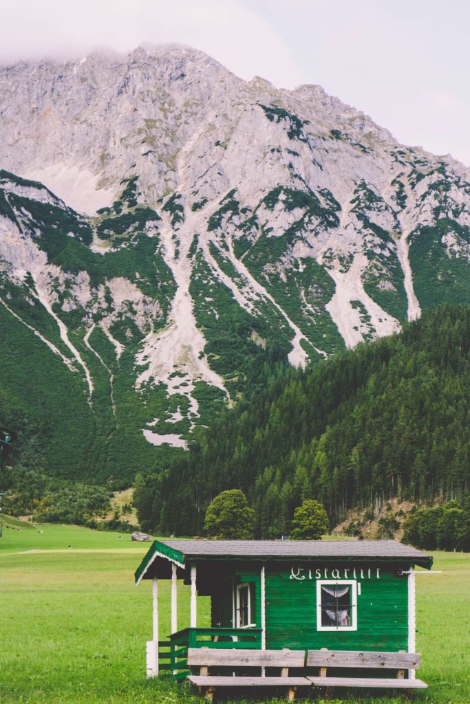 A picturesque little wooden hut in Ramsau am Dachstein in front of the Dachstein mountain range