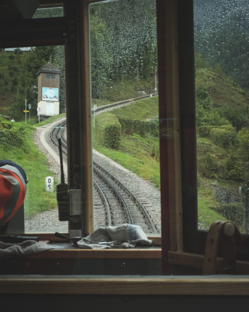 On the Schafbergbahn looking through the front window of the train while it is raining