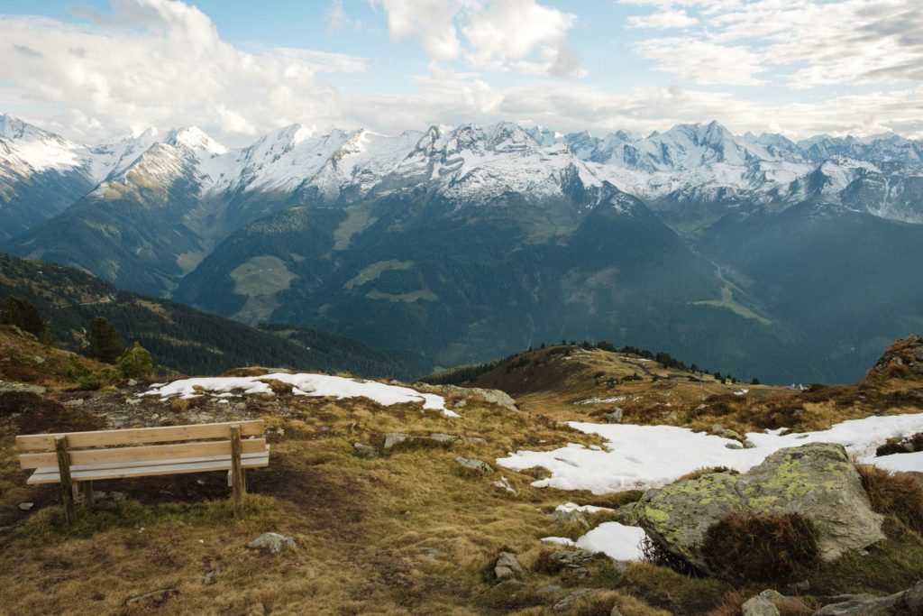 A bench at the top of Karspitze with a mountain range in the background