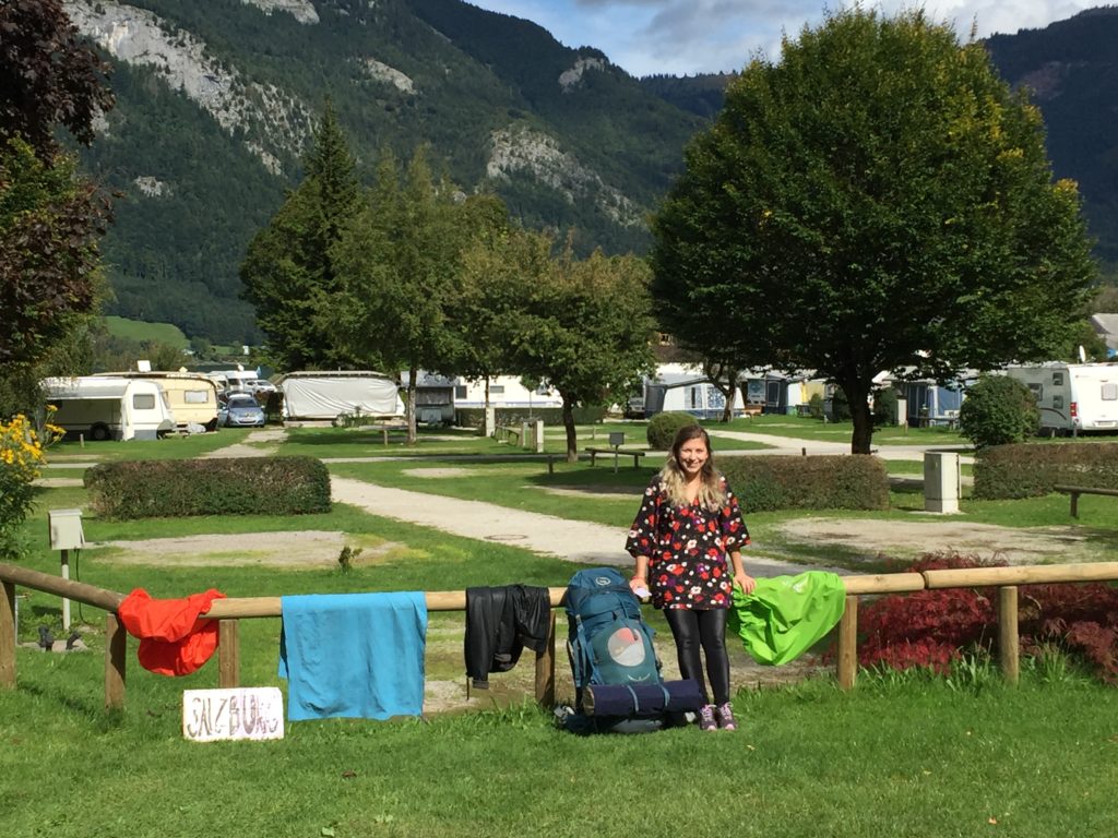 Caroline posing with camping gear which has been hung out to dry at the Wolfgangsee campsite