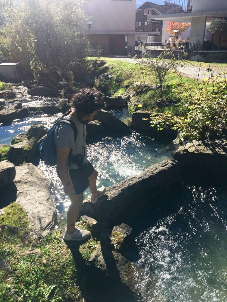 Aydin rock hopping over a stream