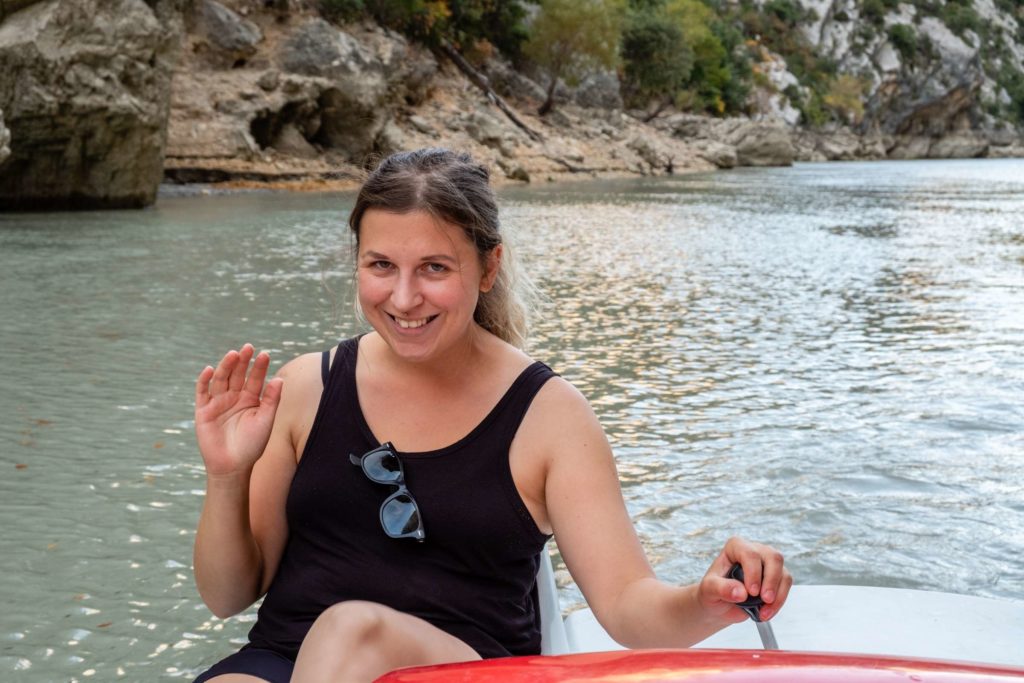 Caroline waving on paddle boat