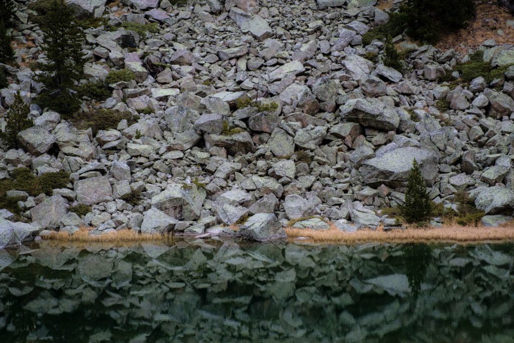 Huge boulders tumbling into small lake