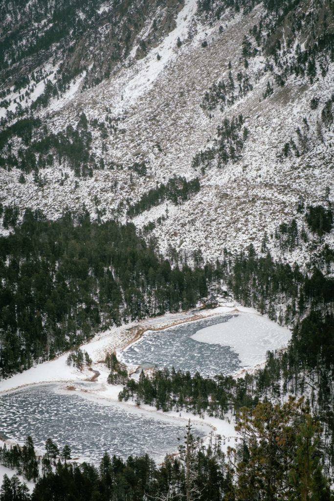 Two frozen lakes from above in Aigüestortes i Estany of Saint Maurici national park