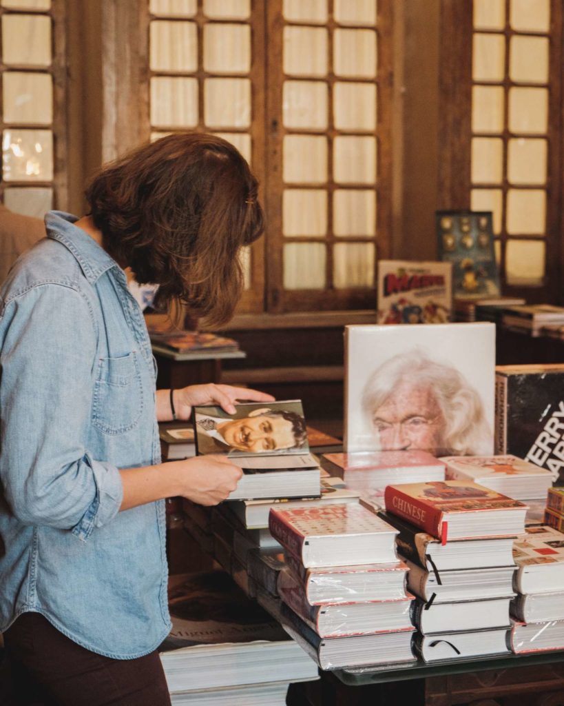 A lady reading a book in Livraria Lello