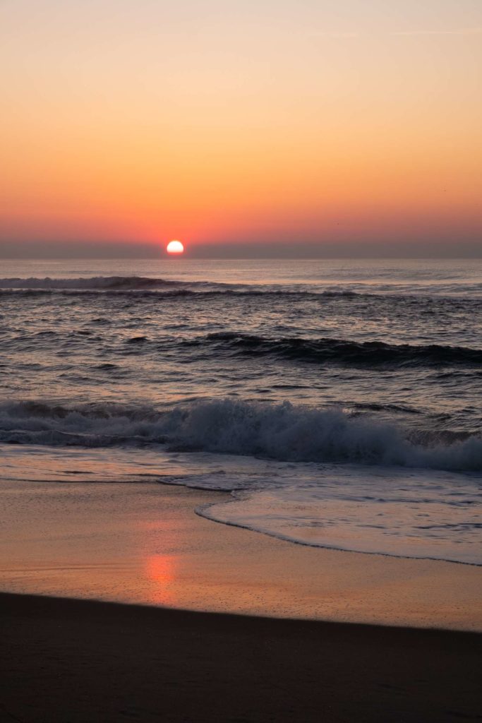 Aveiro beach sunset with sun reflecting on beach