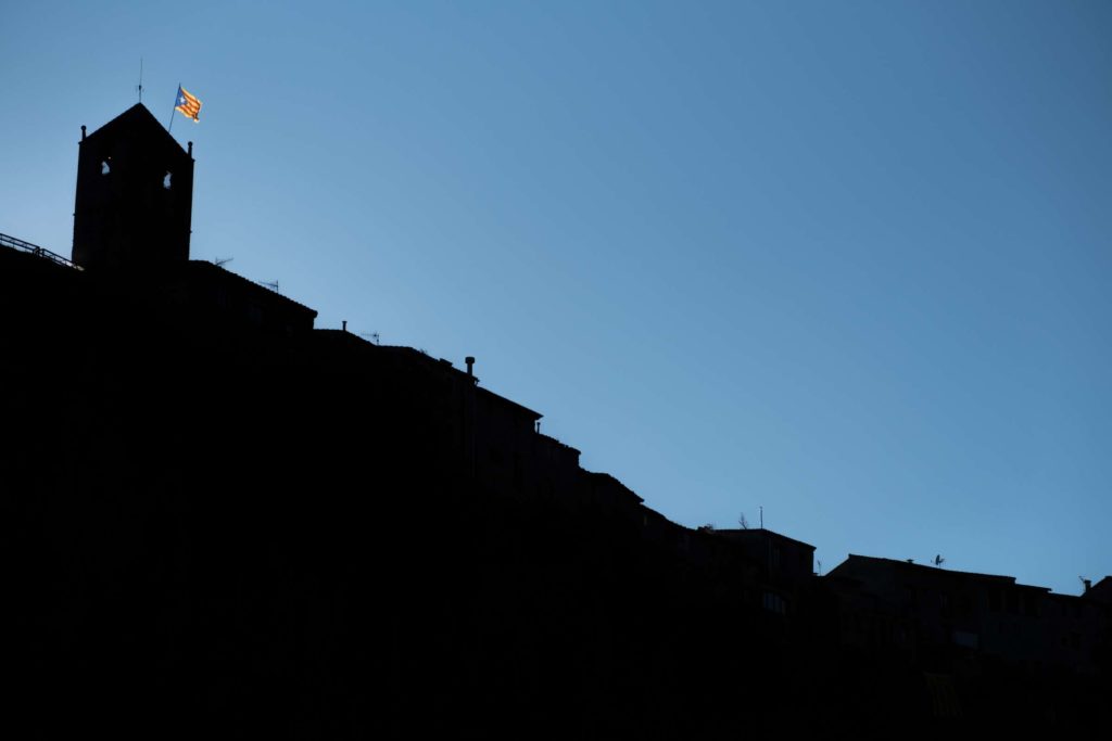 Castellfollit de la roca silhouette with Catalonia flag waving