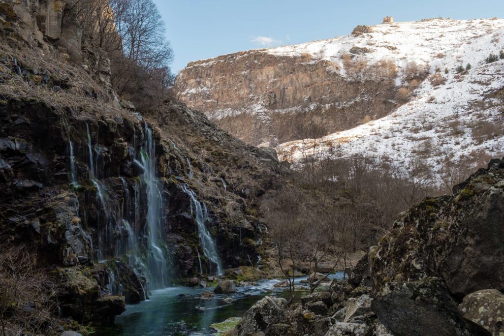 Dashbashi waterfalls from behind with church in the background