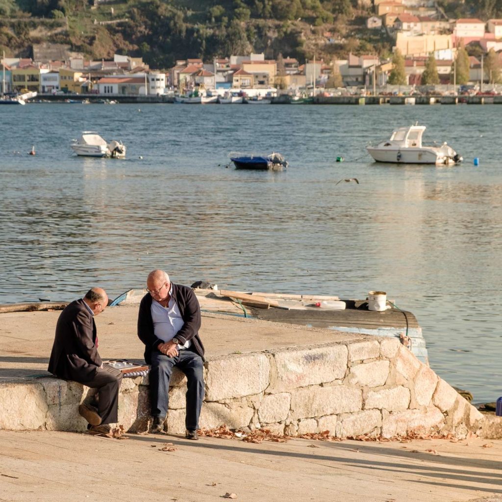 Men playing checkers by the river