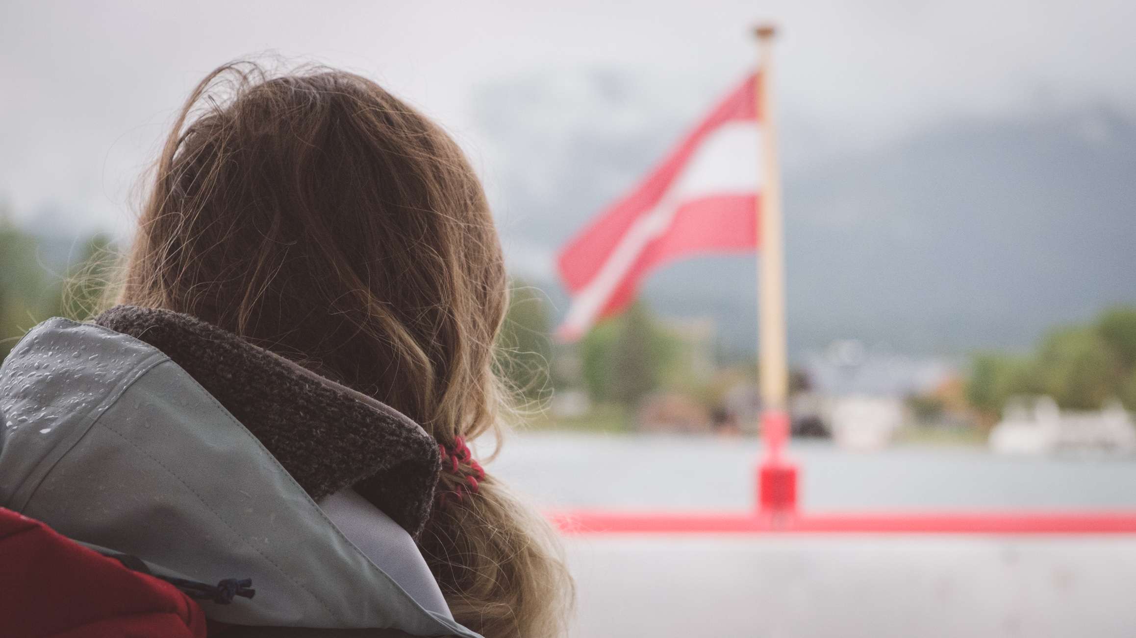 Caroline on the ferry to St Wolfgang with the Austrian flag blowing in the breeze
