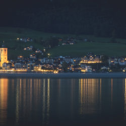 St Wolfgang at night reflecting in the lake from the opposite shore
