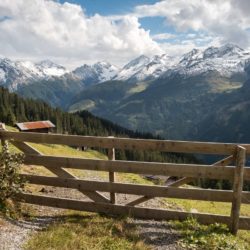 Mountain views with a cute wooden gate with towering mountains behind