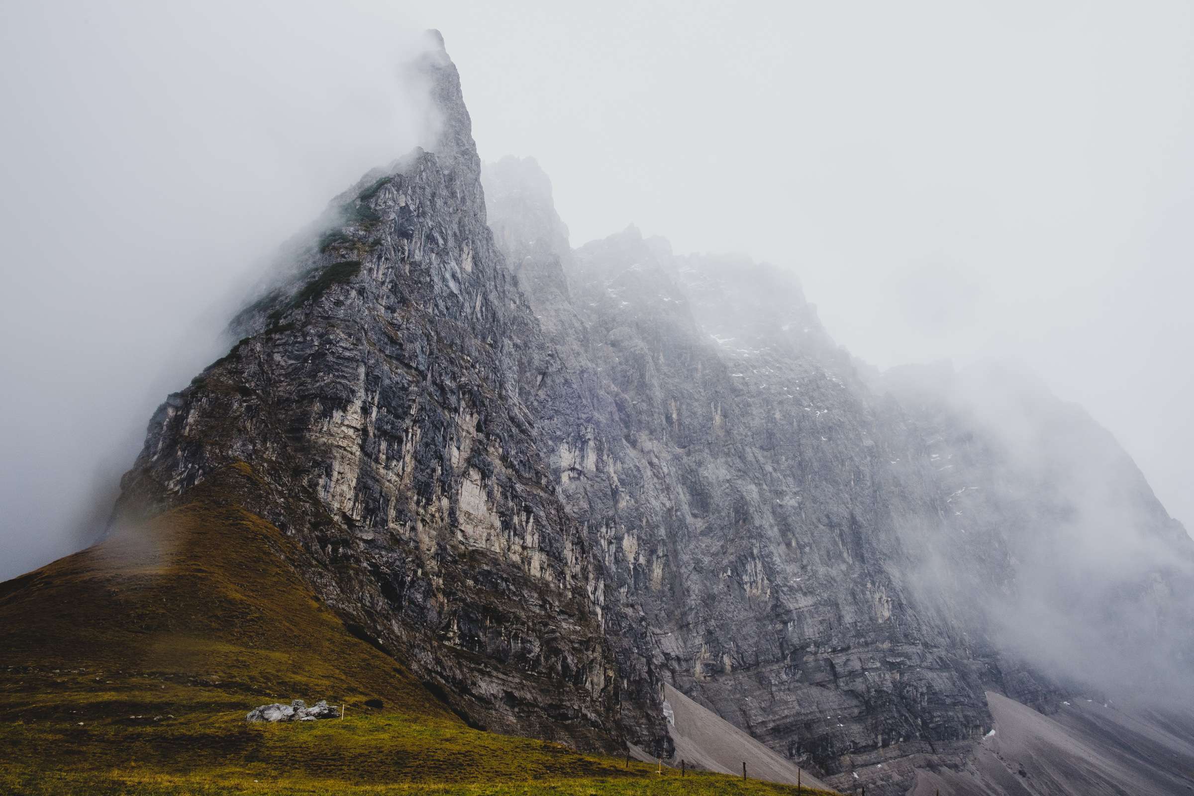 A wall of mountains forming a barrier against the clouds