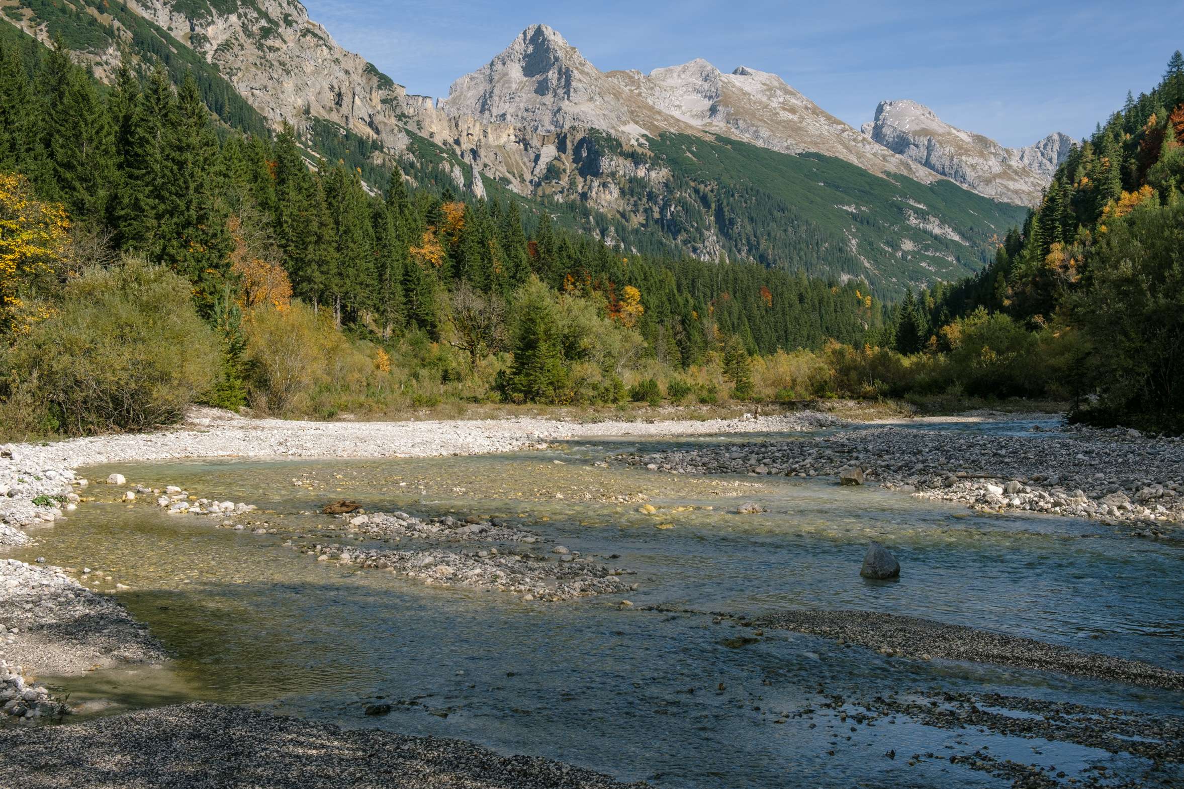 The river shallows and widens engulfing the valley in the Karwendel mountains