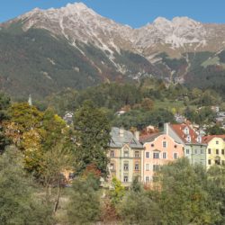 Beautiful pastel houses flanked by huge mountains