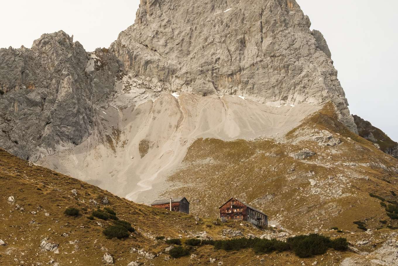 A closer shot of Lamsenjochhütte, a large wooden mountain hut
