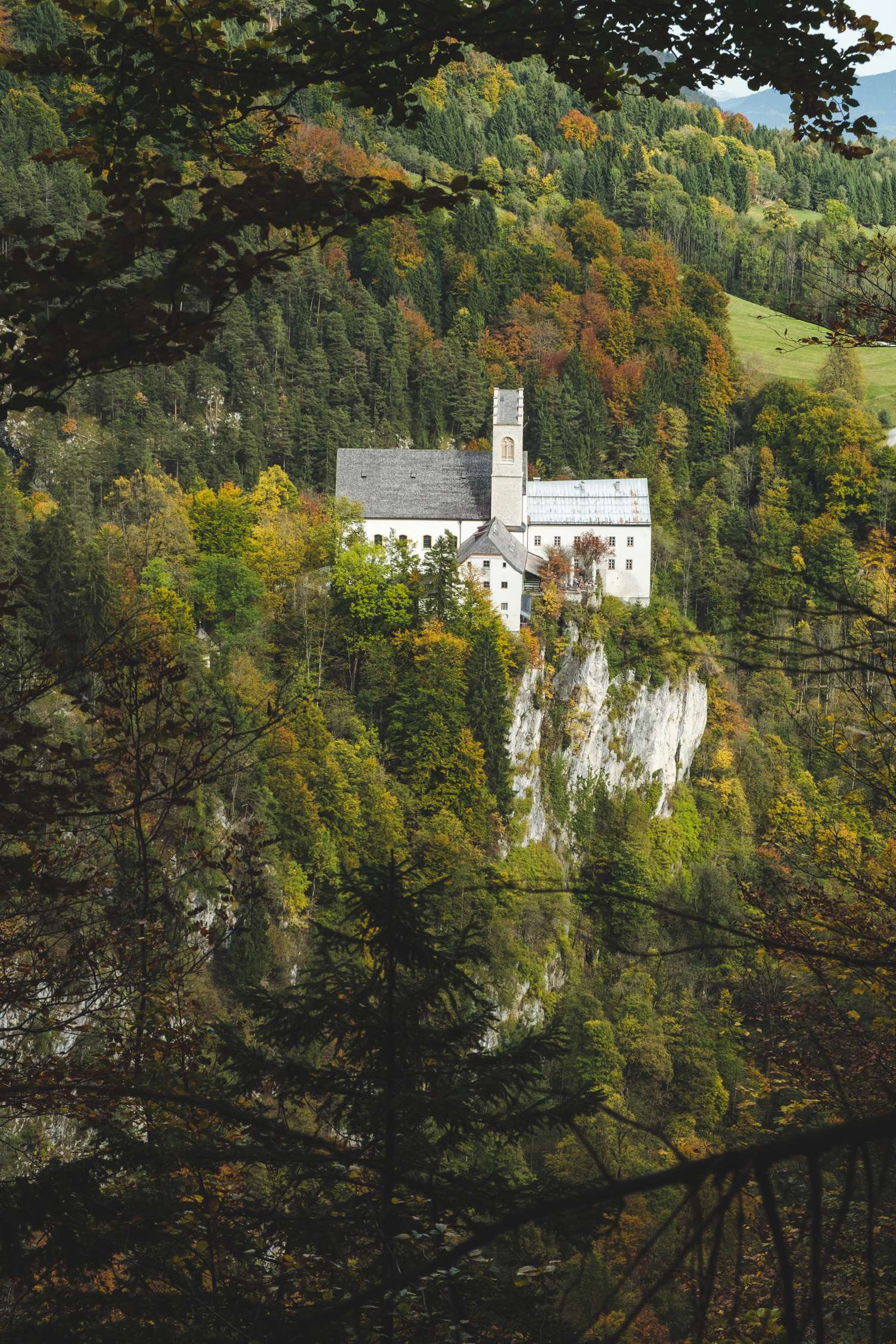 St. Georgenberg monastery. A monastery perched on a rock surrounded by autumn forest