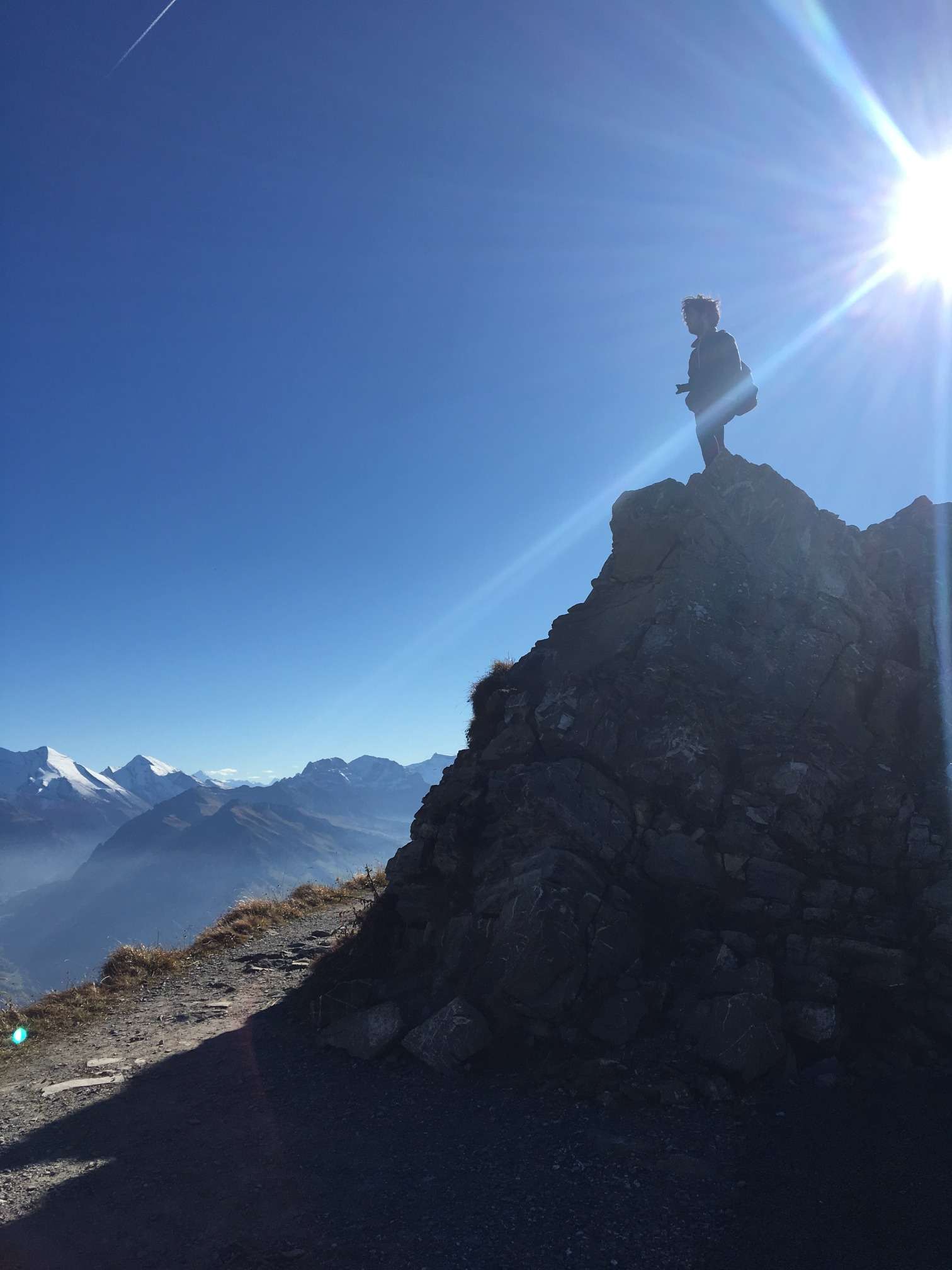 Aydin on top of a rock on the top of Niesen