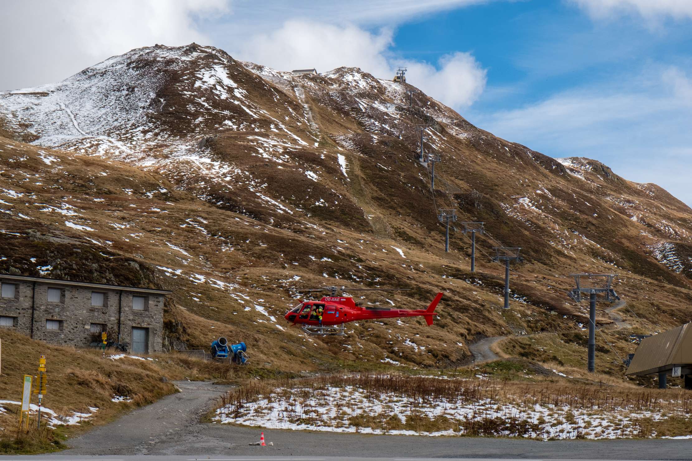 A red helicopter taking off on Oberalppass