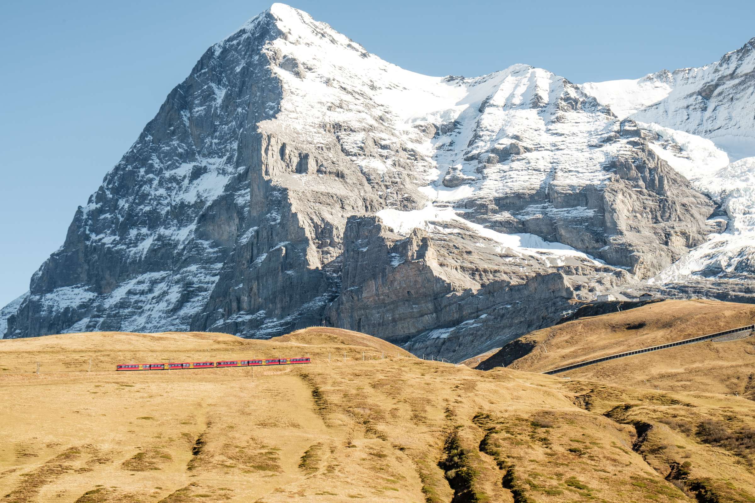 Jungfrau train with huge mountains behind it