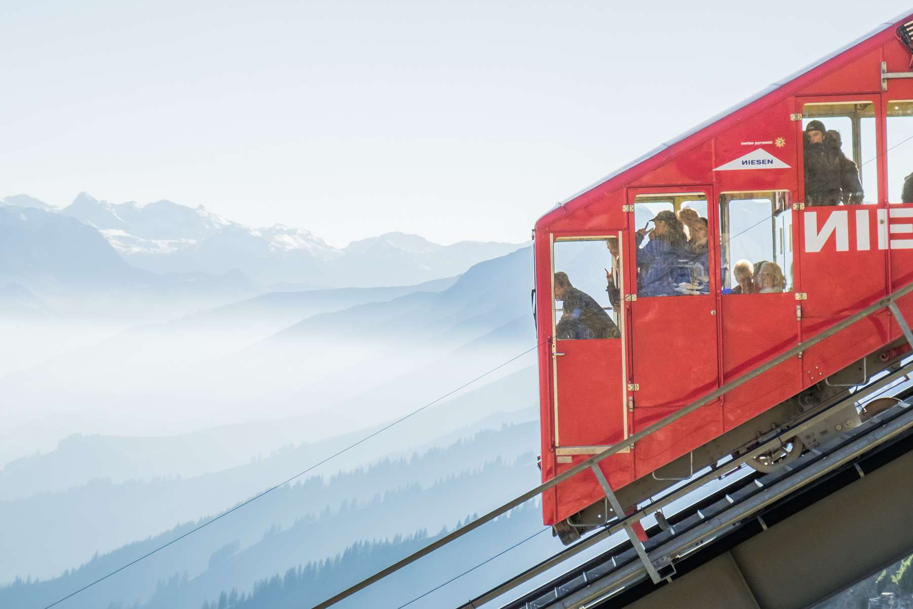 Super closeup of the Niesenbahn with people looking out the windows