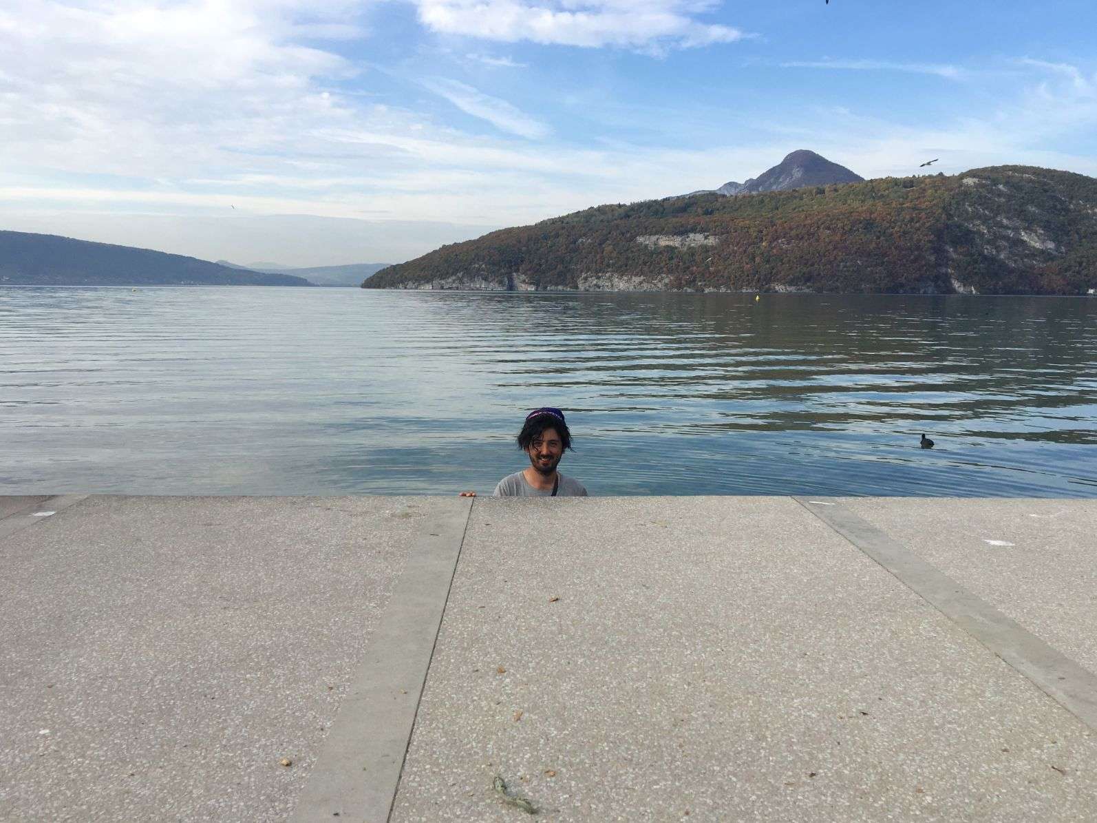 Aydin eating his eclair in lake Annecy