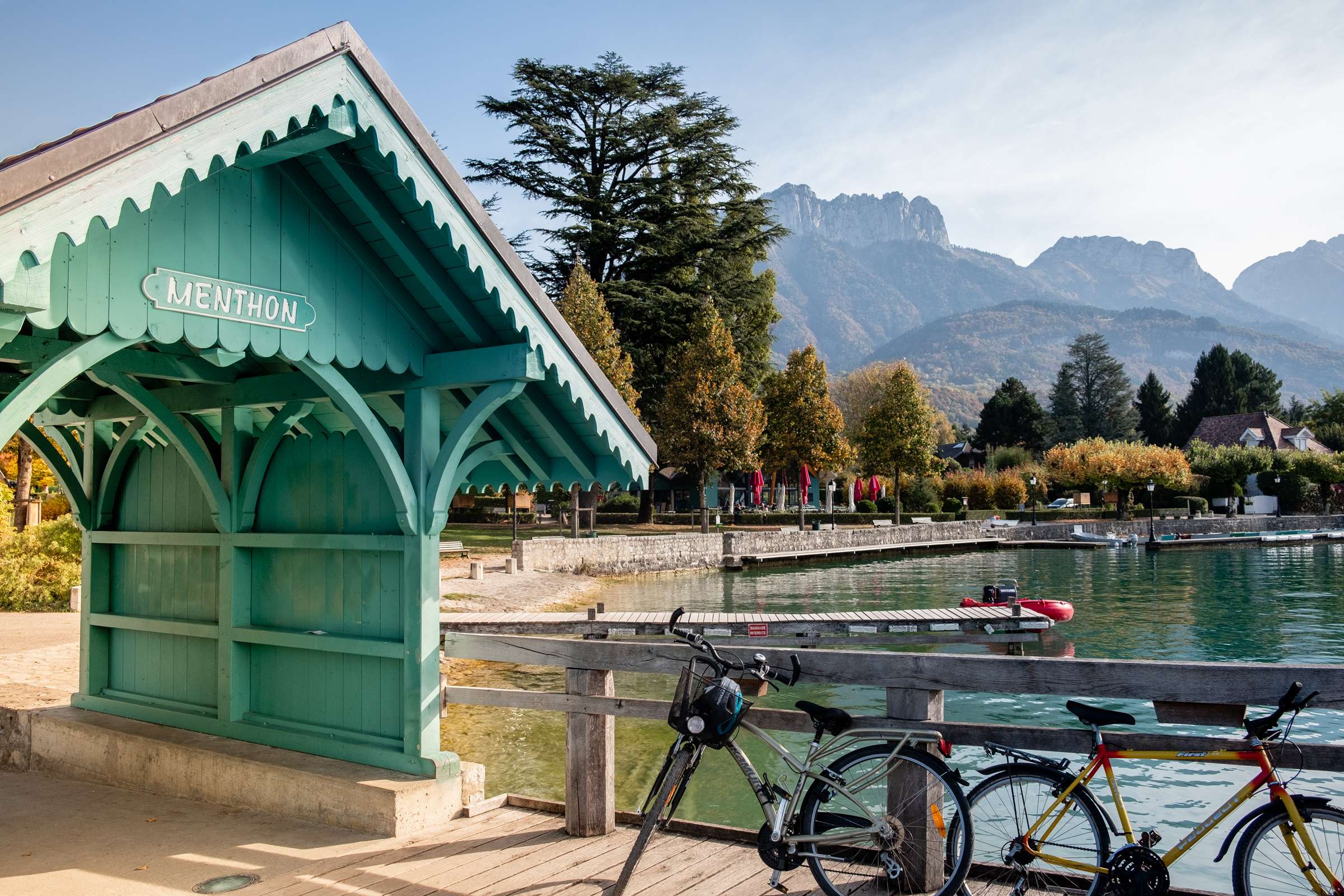A cute turquoise wooden archway on a boardwalk to lake Annecy