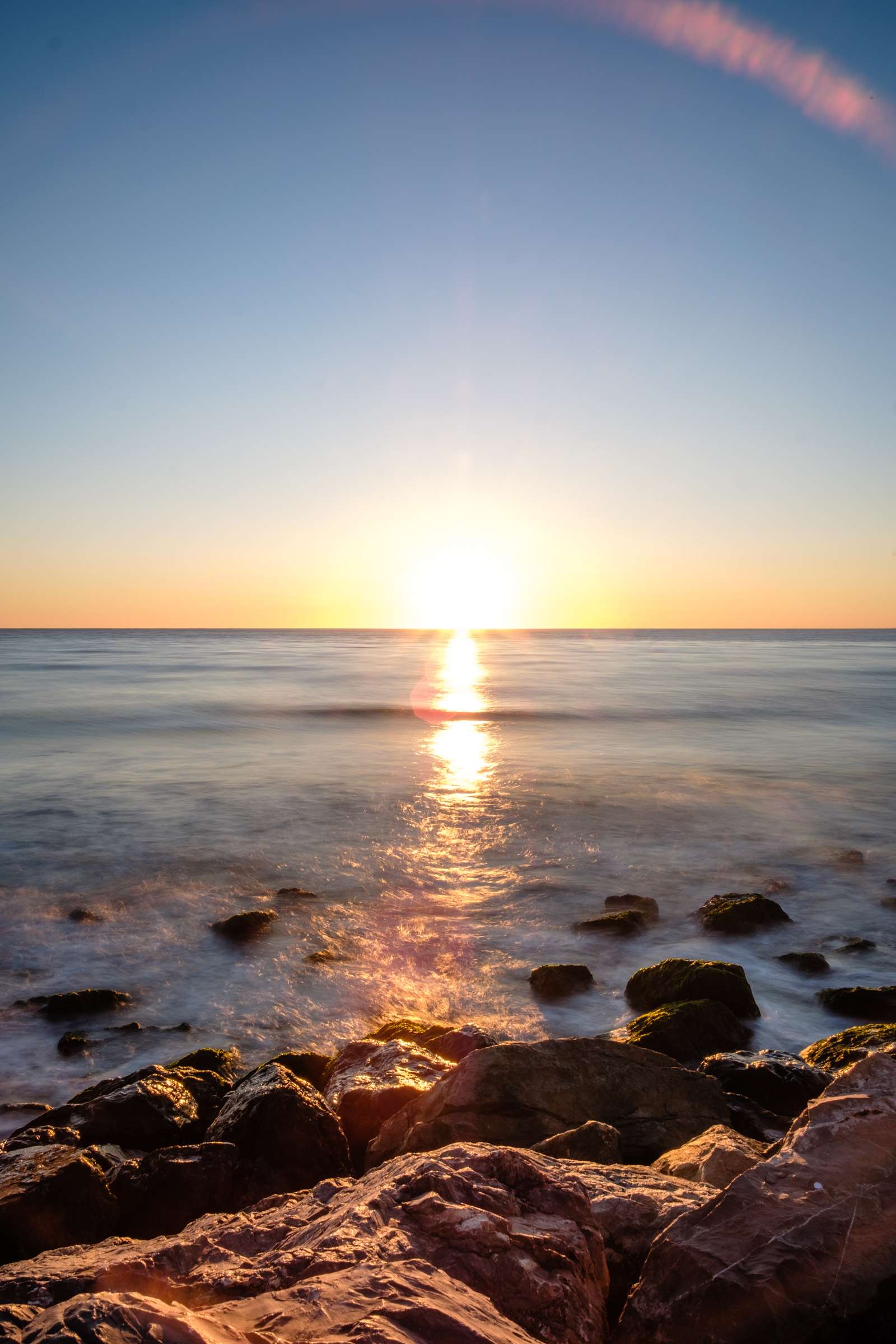 Camargue sea sunset over rocks with a long exposure