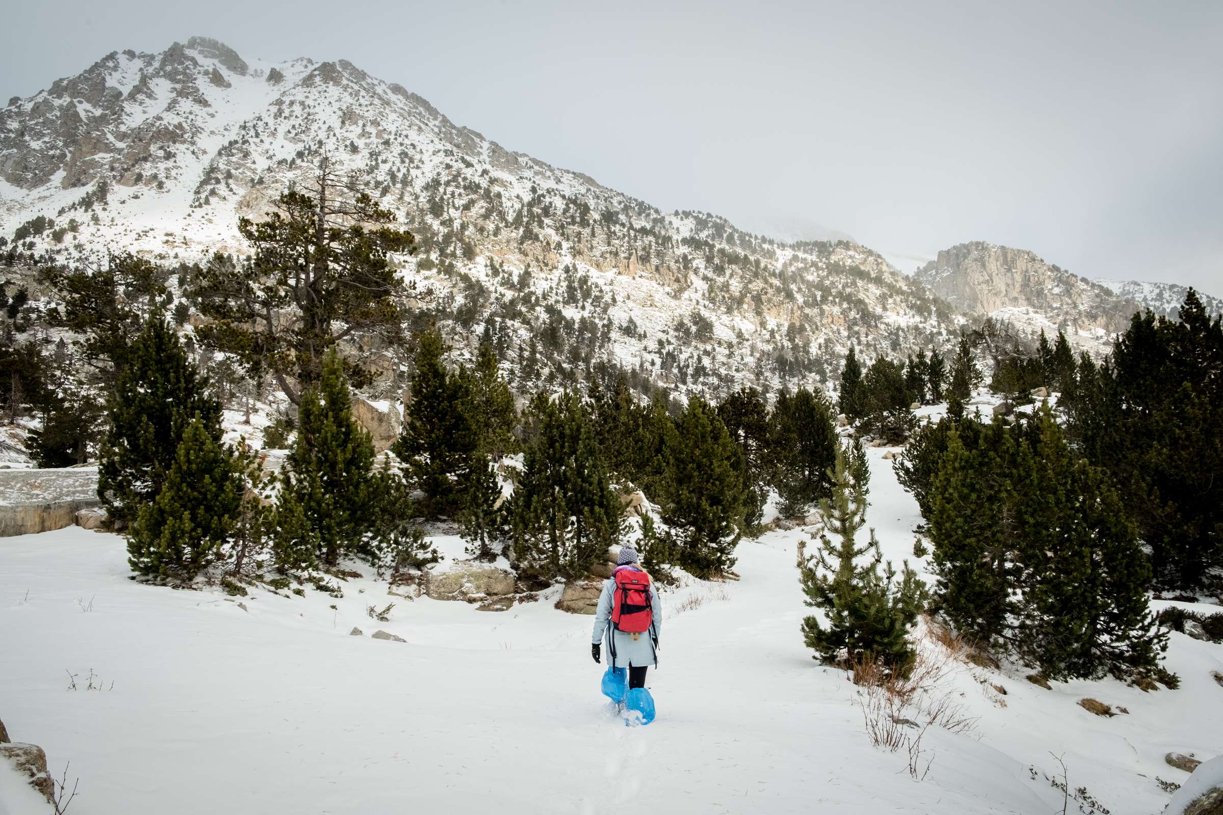 Caroline hiking through snow wearing plastic bags underneath shoes