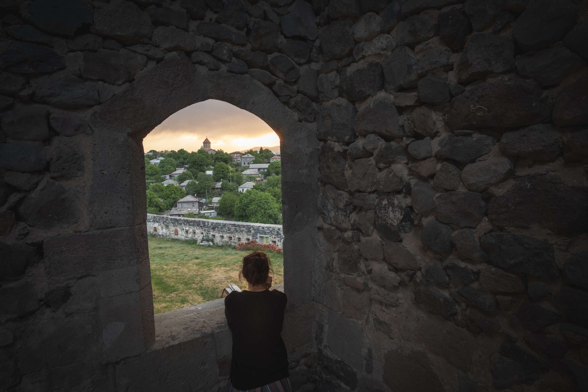 View from Rabati Castle through a window on Akhaltsikhe, Samtskhe-Javakheti, with Caroline in front