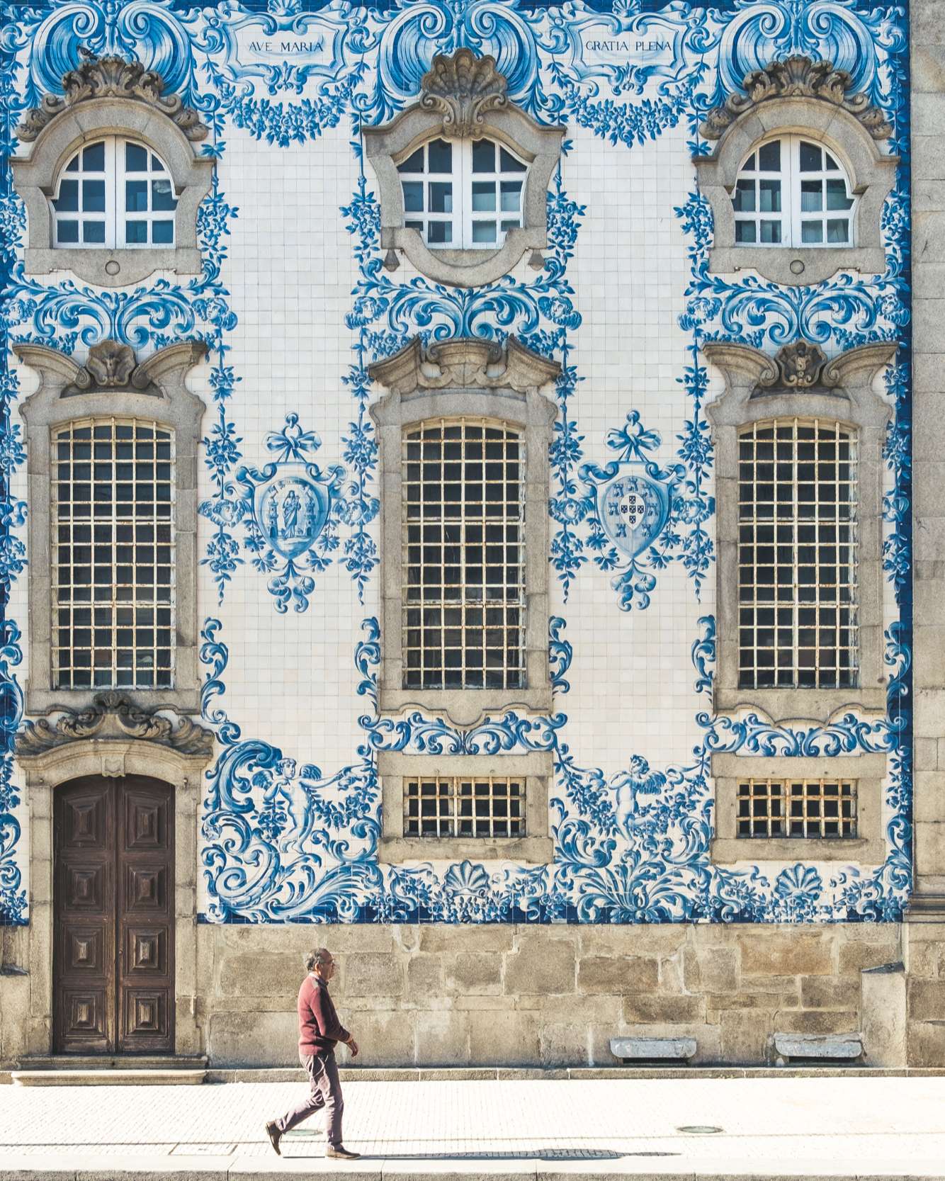 Man walking past Igreja do Carmo