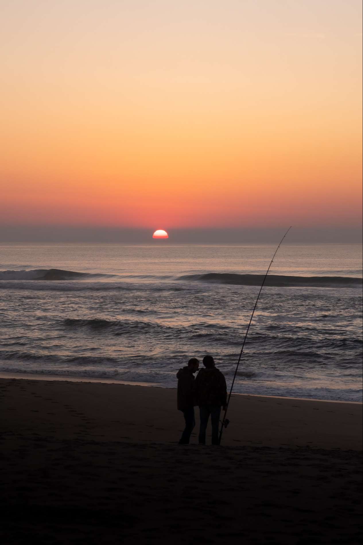 Silhouettes of fisherman on Praia da Costa Nova