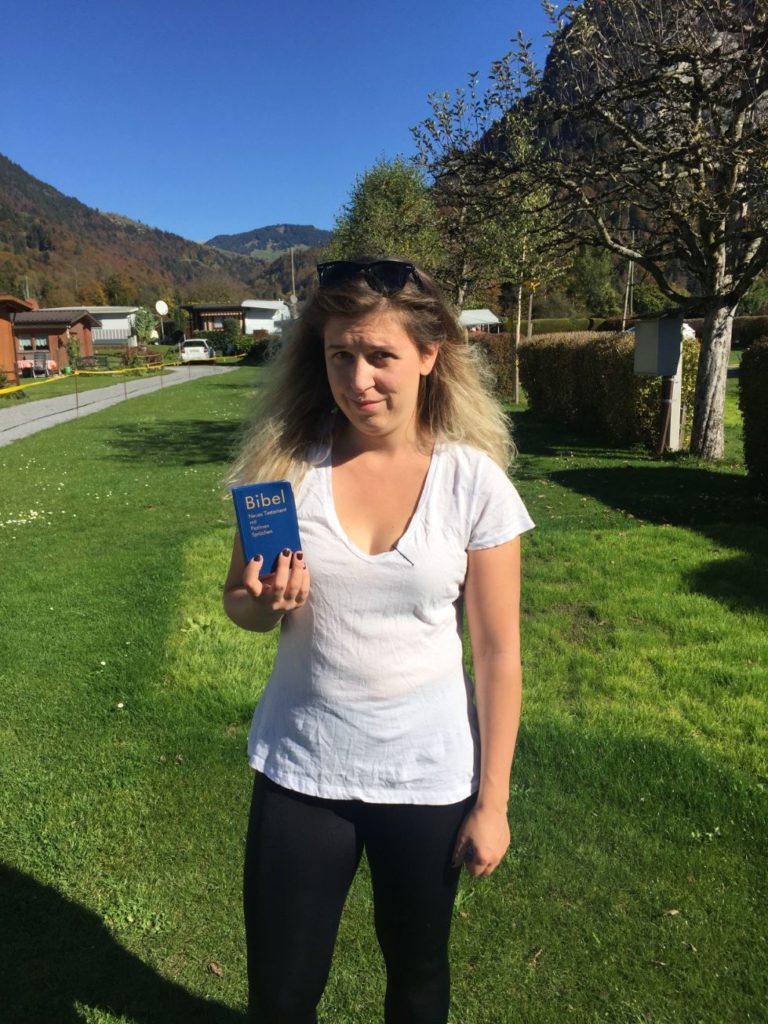 Caroline holding a bible given to her while hitchhiking