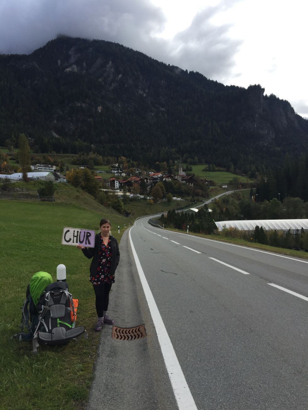 Caroline holding the hitchhiking sign outside of Filisur