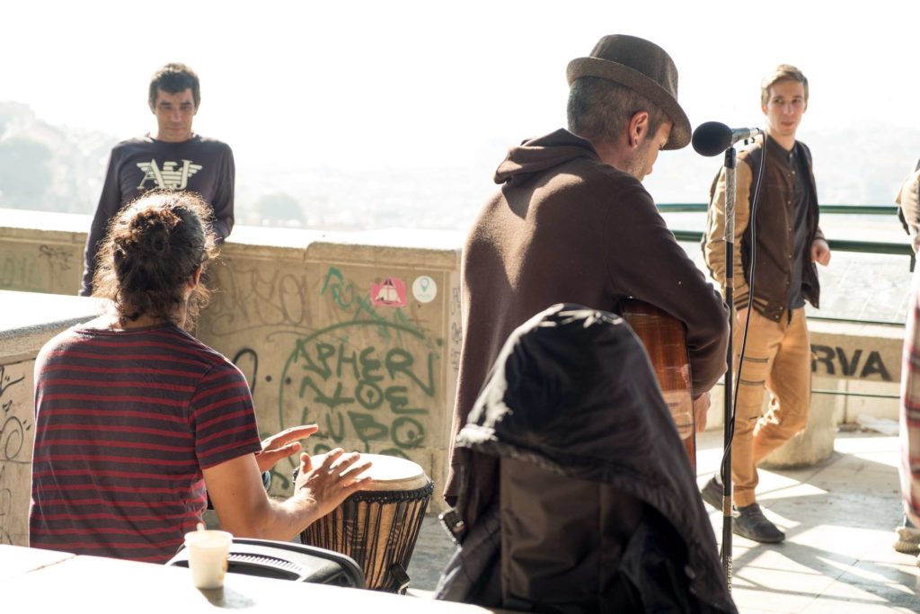 Band playing with audience at Miradouro da Graca viewpoint