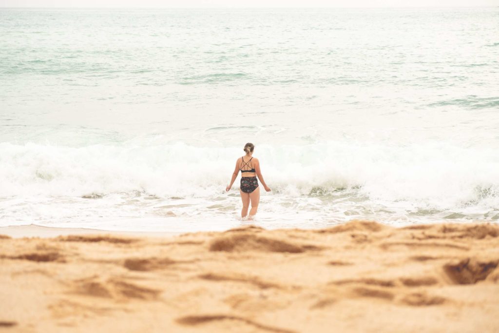 Caroline in the water at Praia da Marinha beach
