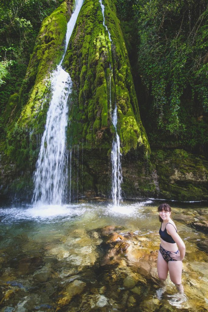 Caroline standing in front of Kaghu waterfall (კაღუს ჩანჩქერი) on Abasha river