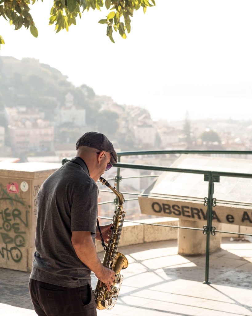 Man playing the Sax at Miradouro da Graca viewpoint