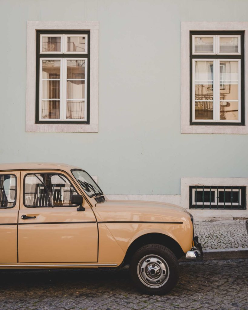 Old mini in front of pretty house in Lisbon