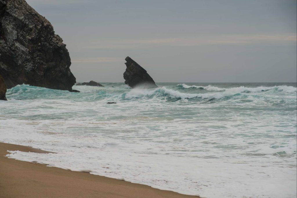 Rocks jutting out the Atlantic at Praia da Adraga beach