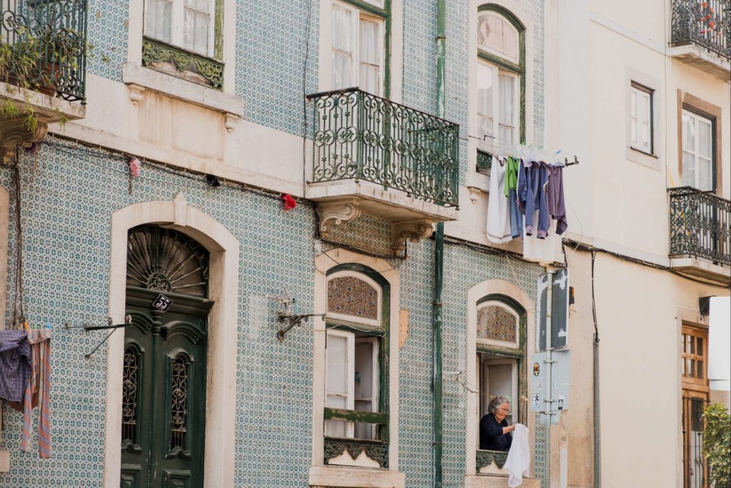 Woman hanging her washing out of her apartment window