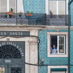 Woman smoking in window of Villa Sousa, Lisbon