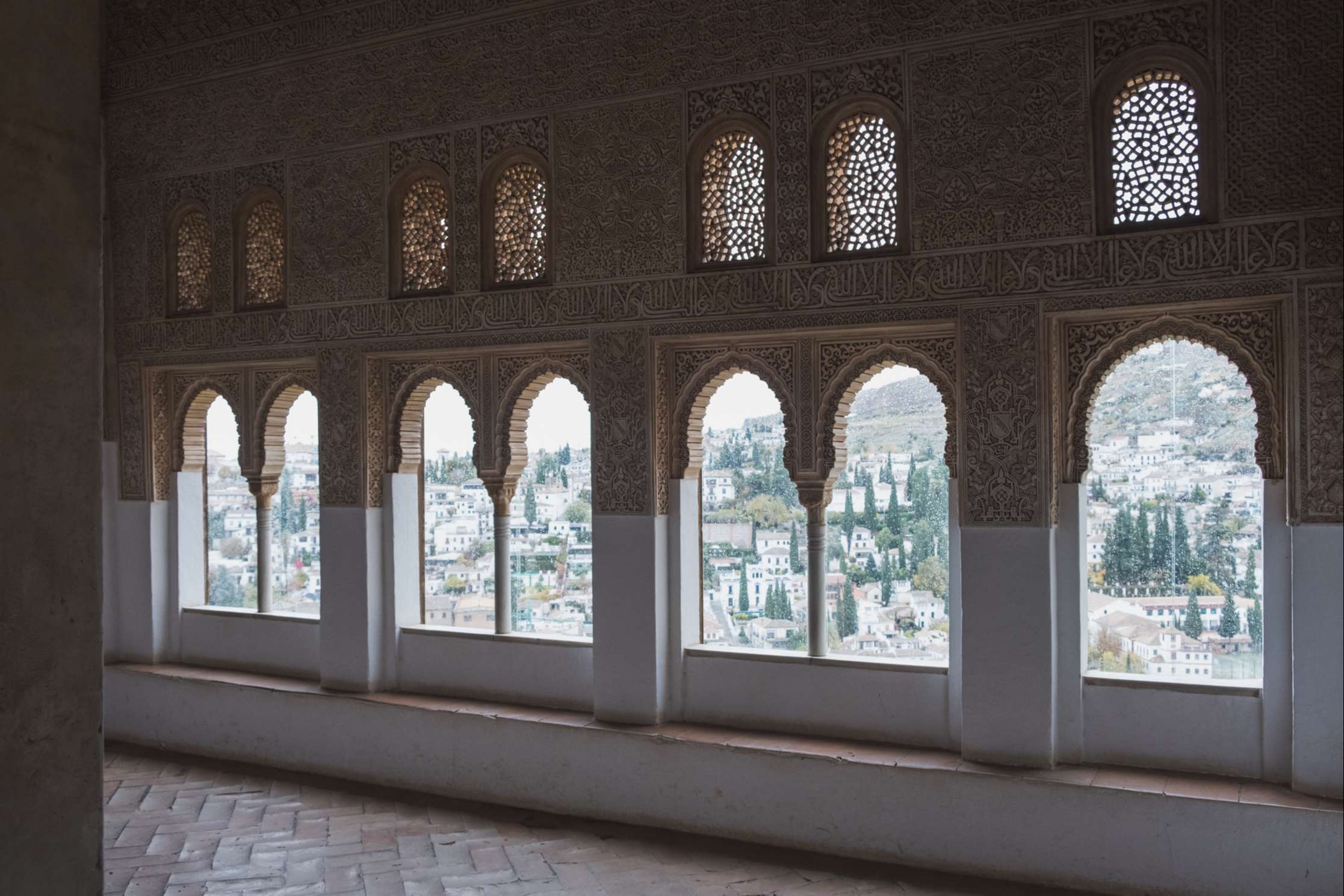 The view over Granada through arched windows in the Alhambra