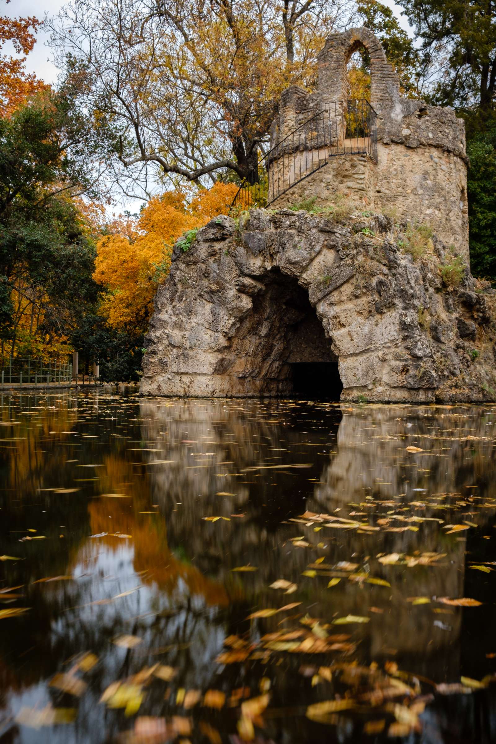 Mini castle reflecting in a pond in Carmen de los Mártires, Granada