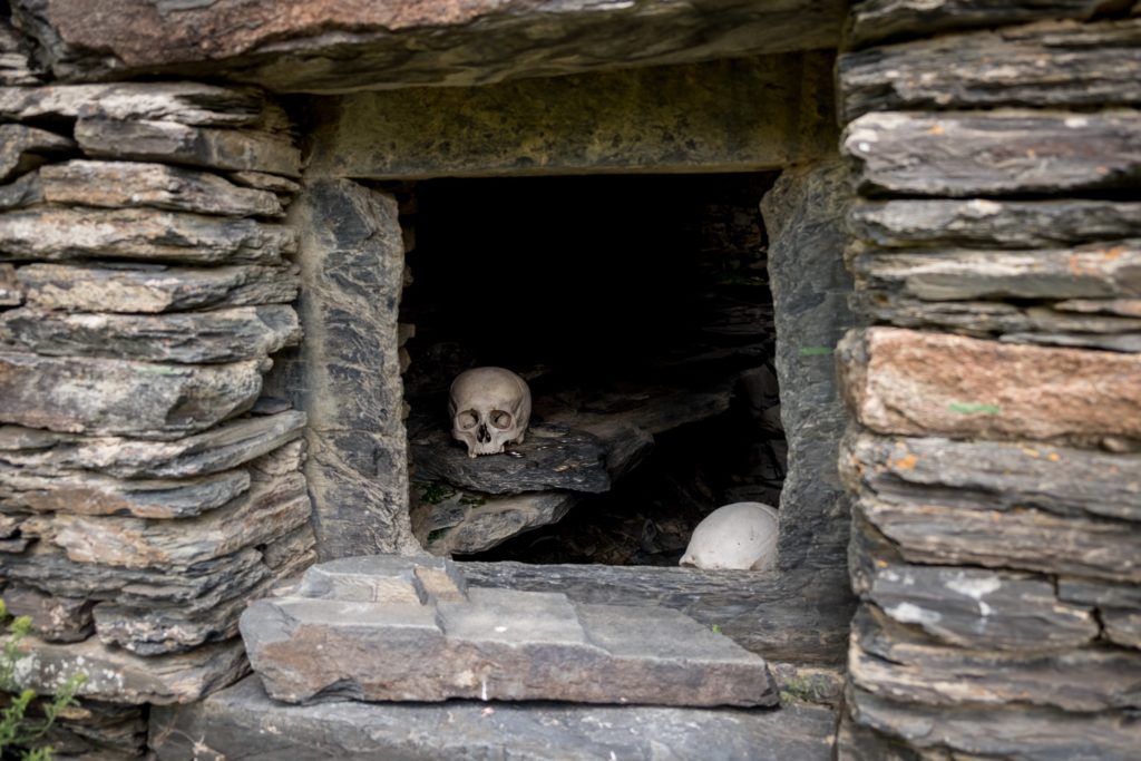 A human skull in a burial tomb or vault in Mutso