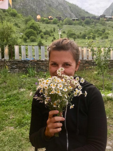 Caroline holding a bunch of flowers in Shatili, Georgia