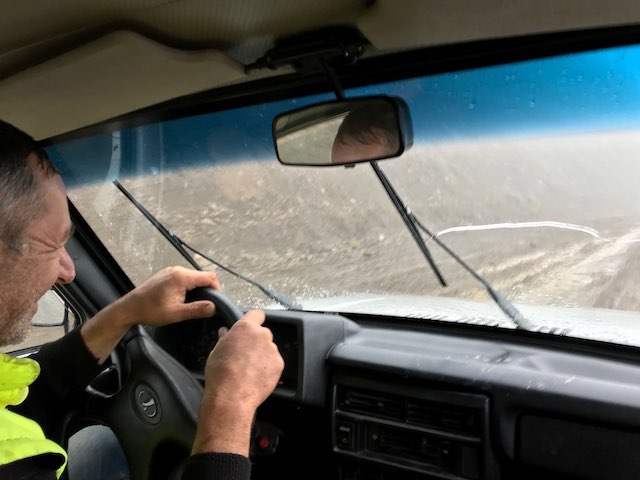 A construction worker driving on the mud road on Datvisjvari pass wheere he pulled our car out