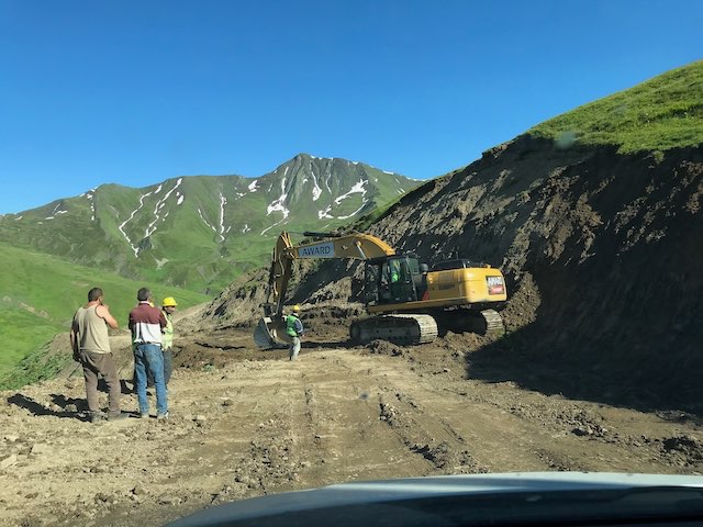 A digger repairing the road ahead of us on Datvisjvari pass in good weather