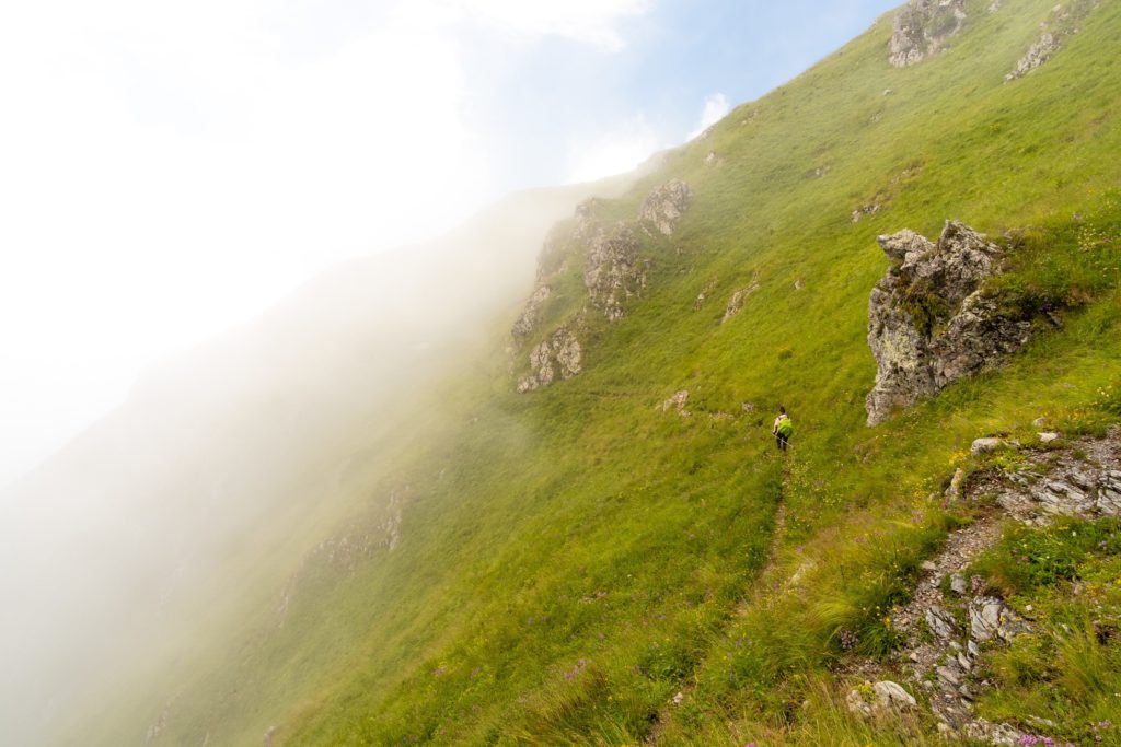 Caroline hiking along a path on a steep grass covered mountain, high in the Caucasus mountains of Lagodekhi protected areas