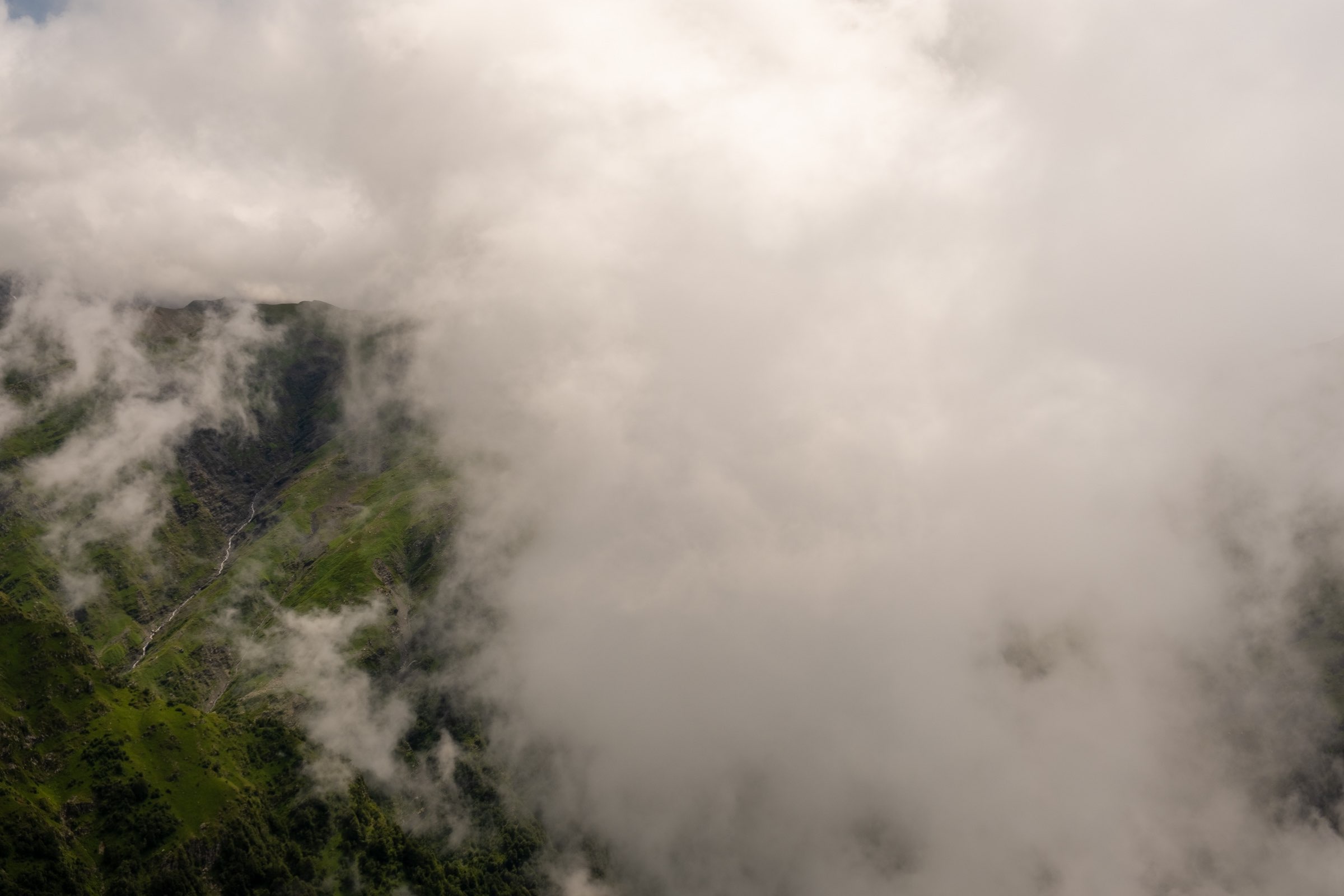 Window to a waterfall through the clouds in the mountains of Lagodekhi Protected Areas, Kakheti, Georgia